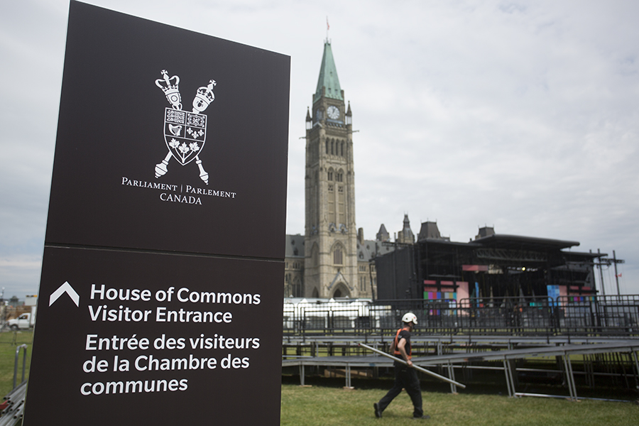 Work crews set up on Parliament Hill ahead of upcoming Canada Day festivities in Ottawa on June 26, 2019.